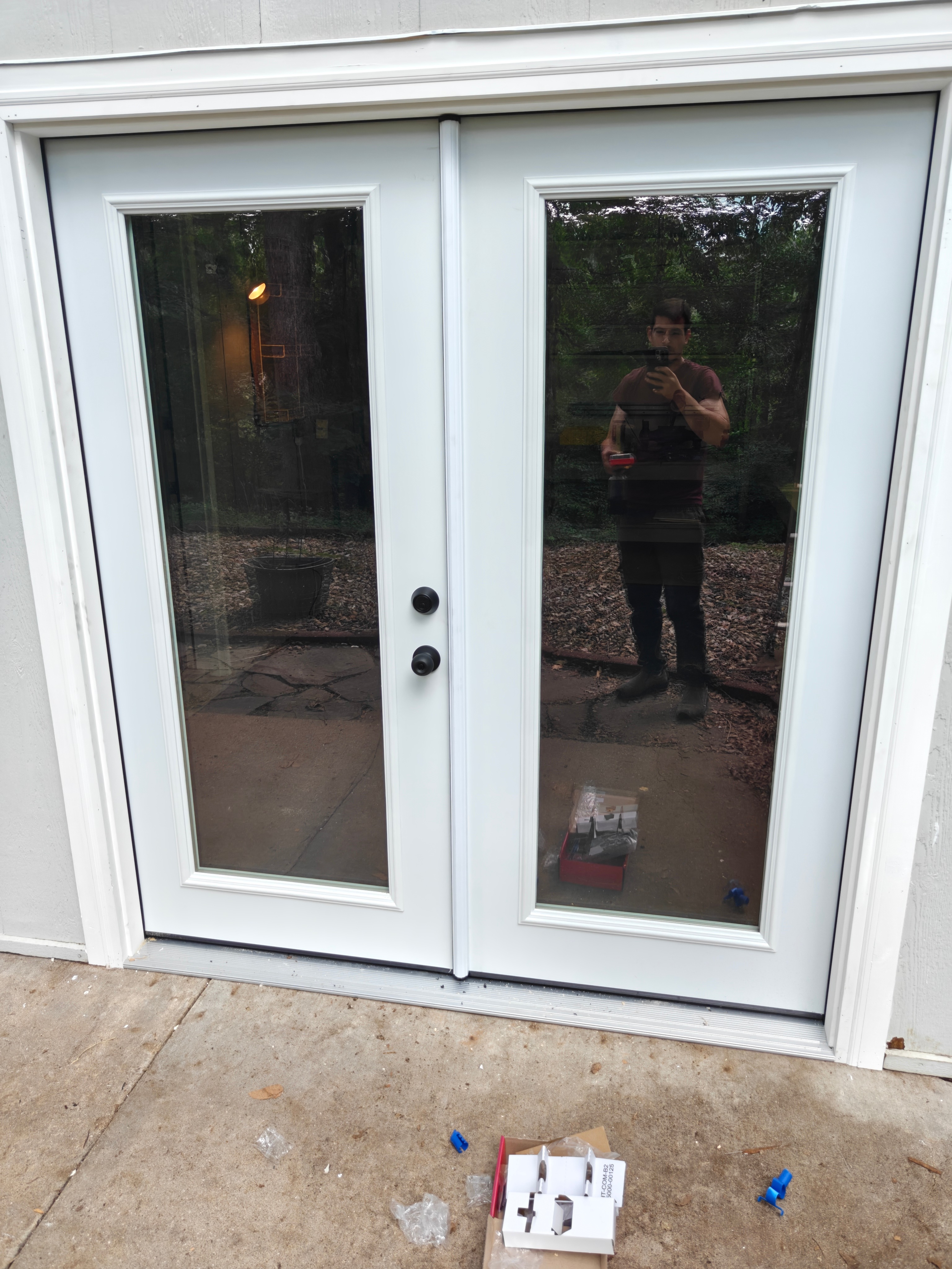 Finished double French patio doors with clean trim and hardware in Bella Vista