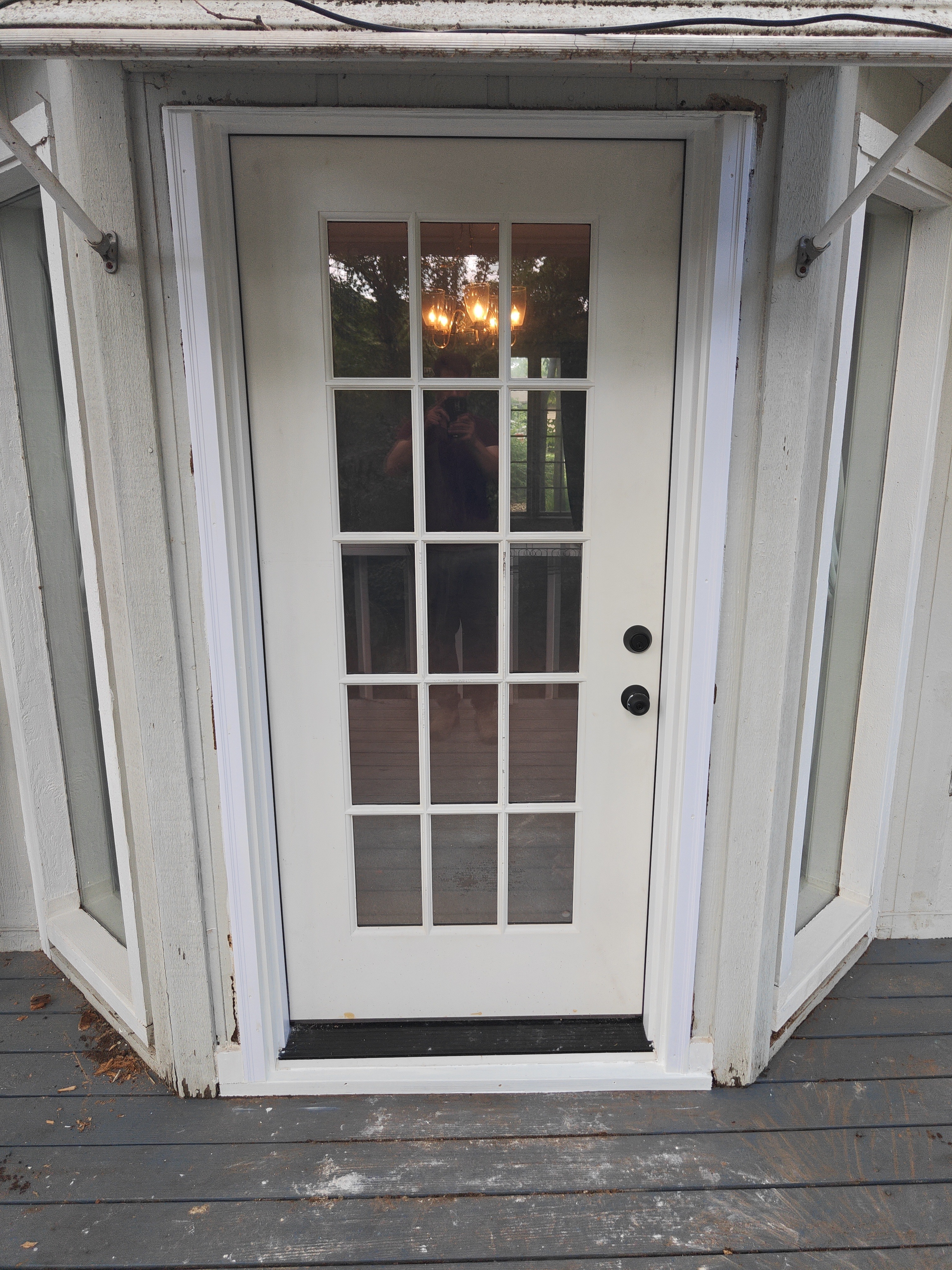 Finished single 15-lite French door with black hardware installed in Bella Vista