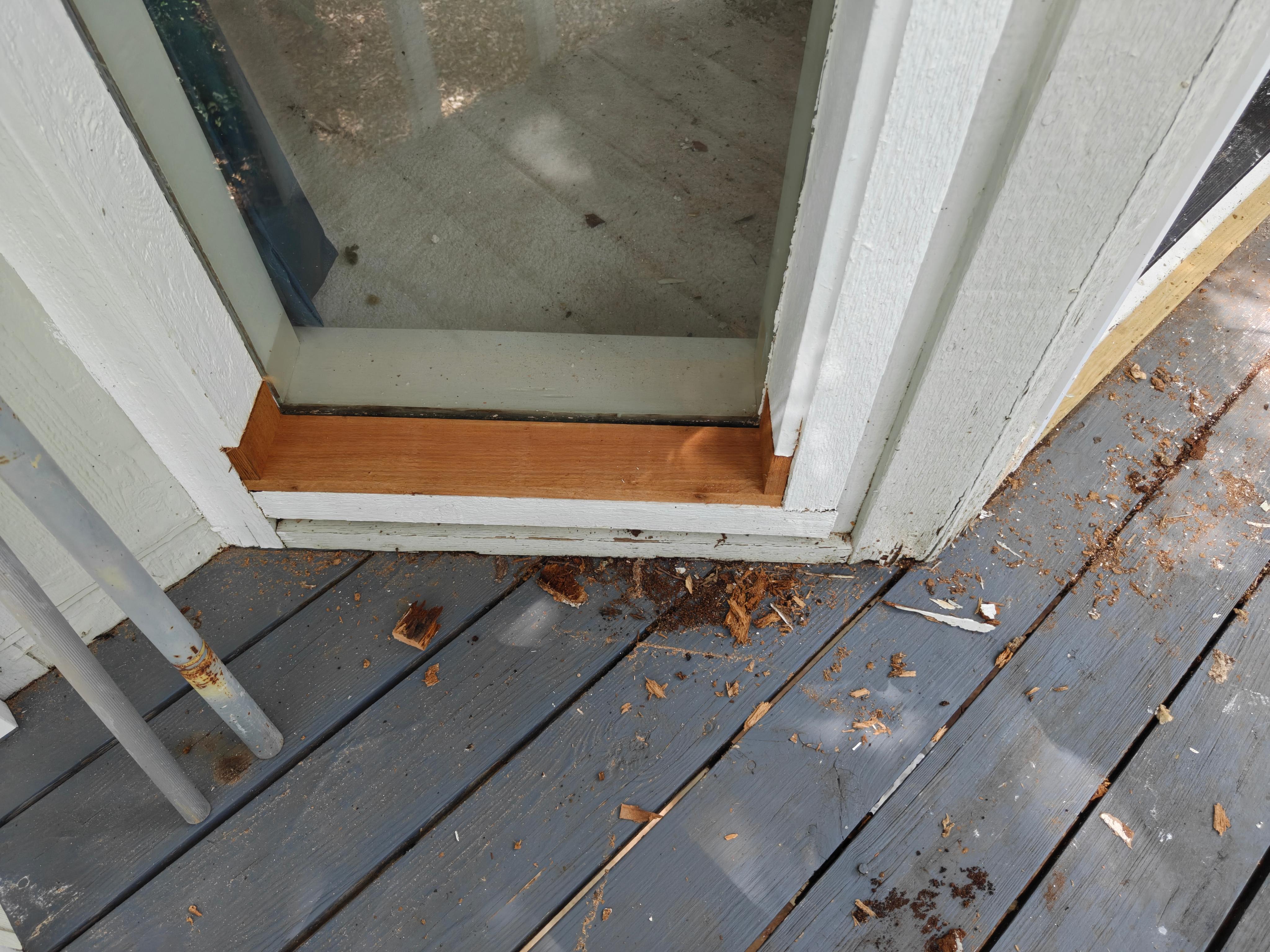 Old rot removed and new oak threshold being fitted at exterior door in Bella Vista